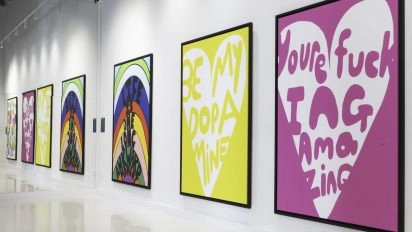 Gallery wall featuring bold text artworks by Robbie Williams, including "You're fucking amazing," at Moco Museum Barcelona.
