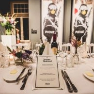 Formal dinner setup with floral decor at Moco Museum celebration.