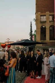 Attendees on red carpet outside Moco Museum Amsterdam event.